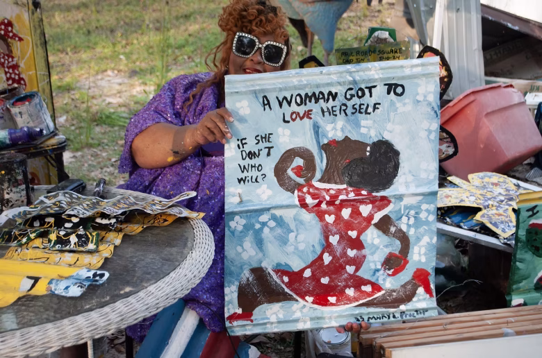 Artist Mary Proctor holds one of her artworks. Proctor's art will be on view in a new two-year solo exhibition at the American Visionary Art Museum, debuting Aug. 2, 2025. Photo courtesy American Visionary Art Museum.