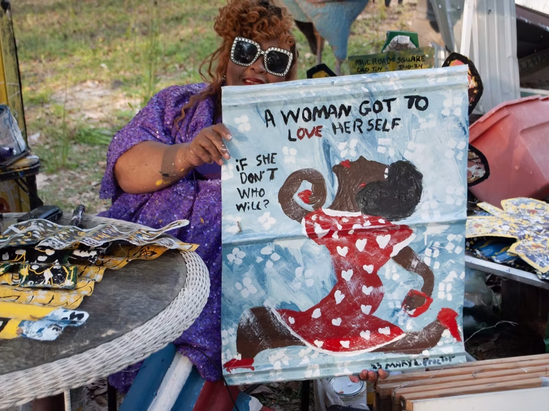 Artist Mary Proctor holds one of her artworks. Proctor's art will be on view in a new two-year solo exhibition at the American Visionary Art Museum, debuting Aug. 2, 2025. Photo courtesy American Visionary Art Museum.